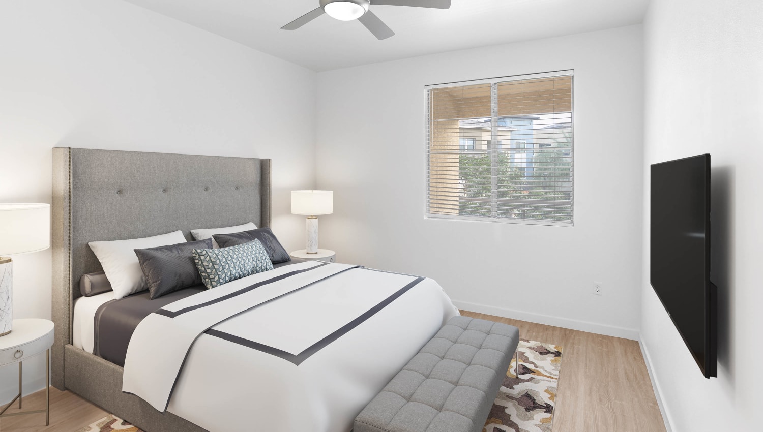 Well-furnished primary bedroom with plush carpeting in a model home at Vistara at SanTan Village in Gilbert, Arizona