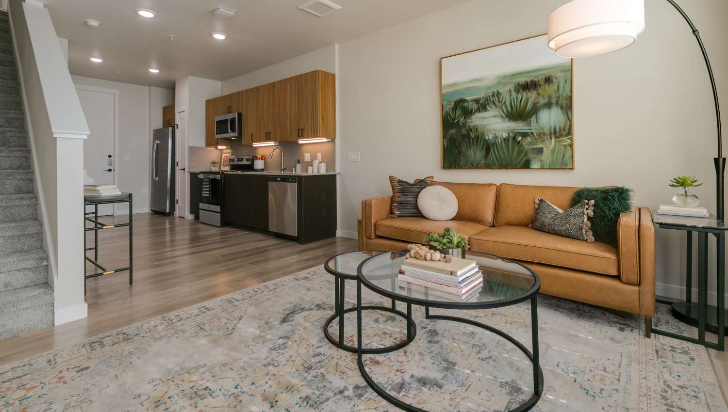 Modern living room with view of kitchen at Olympus Latitude in Albuquerque, New Mexico