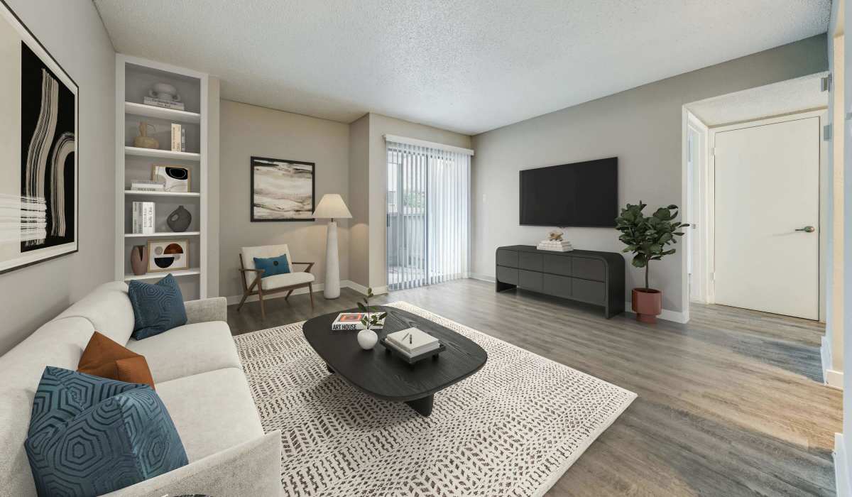 TV setup in living room with a couch at Icon Apartments in San Antonio, Texas