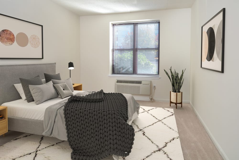 Spacious model bedroom with a large window at The Brunswick in New Brunswick, New Jersey