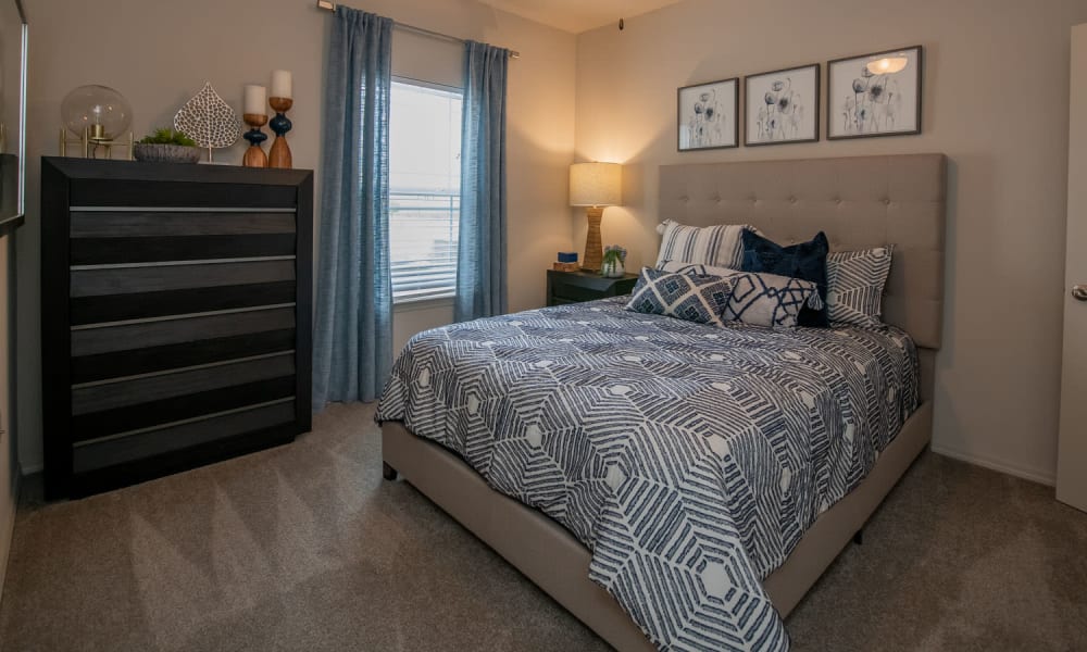 Cozy master bedroom with ceiling fan at Redbud Ranch Apartments in Broken Arrow, Oklahoma