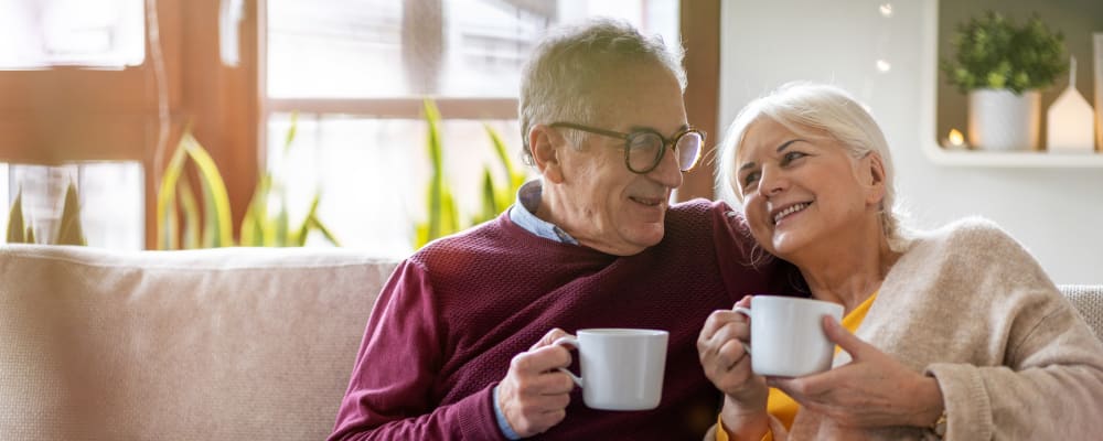 Couple lounging in their senior apartment at The Springs at Happy Valley in Happy Valley, Oregon
