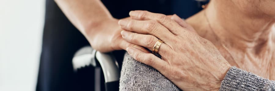 Resident holding their caretaker's hand at Geneva Lake Manor in Lake Geneva, Wisconsin