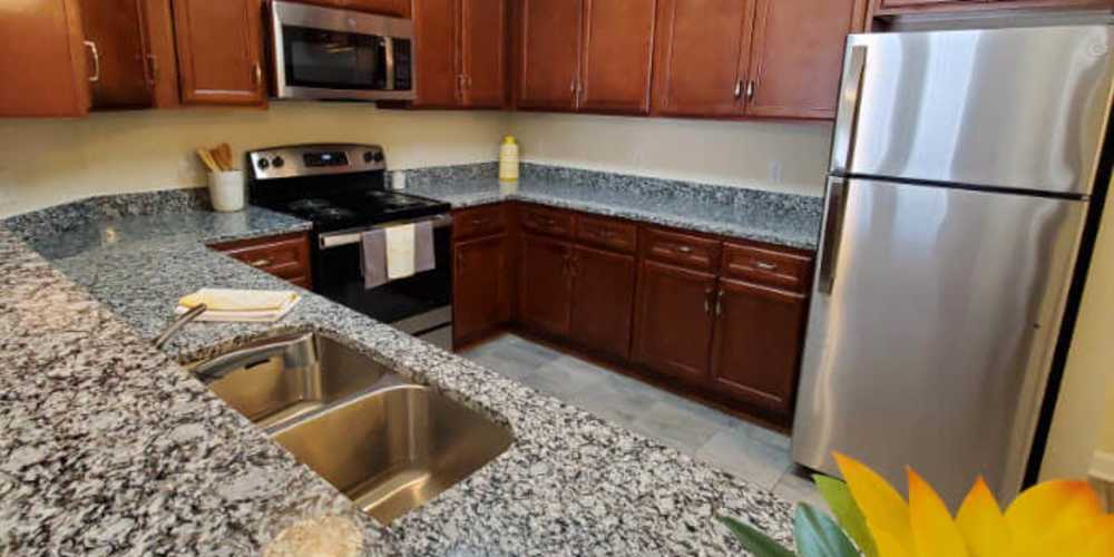 Modern kitchen with stainless-steel appliances at Groves at Peach Orchard in Belmont, North Carolina