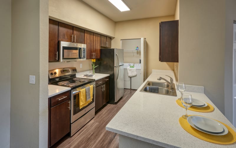 A renovated kitchen with espresso cabinets at The Crossings at Bear Creek Apartments in Lakewood, Colorado
