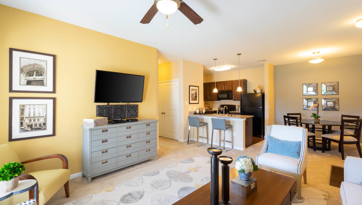 Open-concept floor plan with a ceiling fan in a model home at Legends at White Oak in Ooltewah, Tennessee