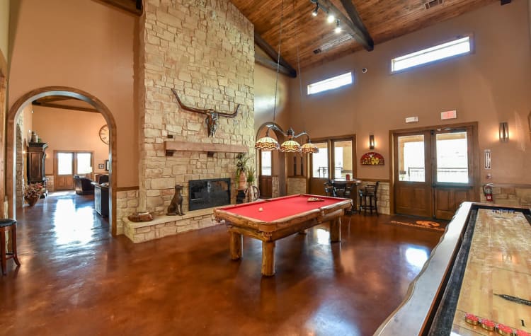 Interior of the luxurious resident clubhouse with plenty of lounge seating at Overlook Ranch in Fort Worth, Texas