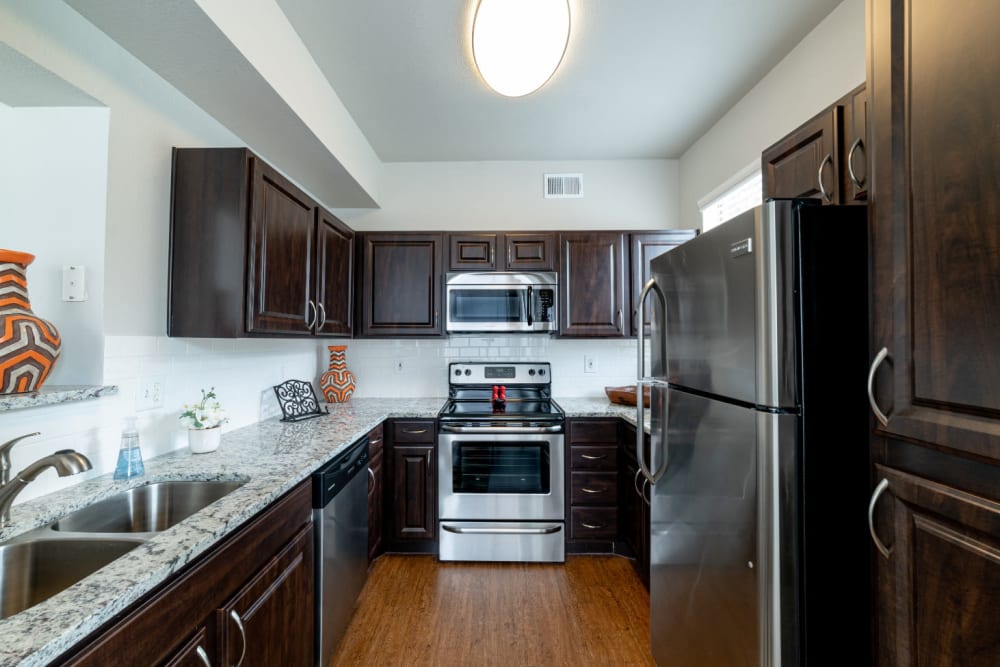 Kitchen with granite counters at Marquis at Lantana in Flower Mound, Texas