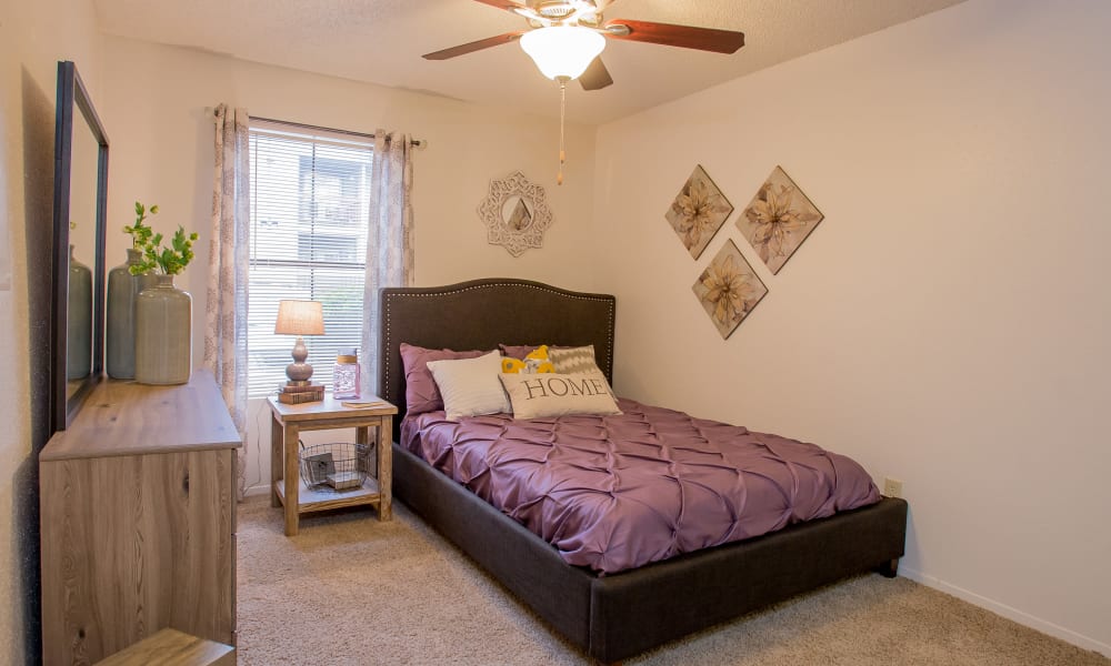 Cozy master bedroom at Cimarron Pointe Apartments in Oklahoma City, Oklahoma