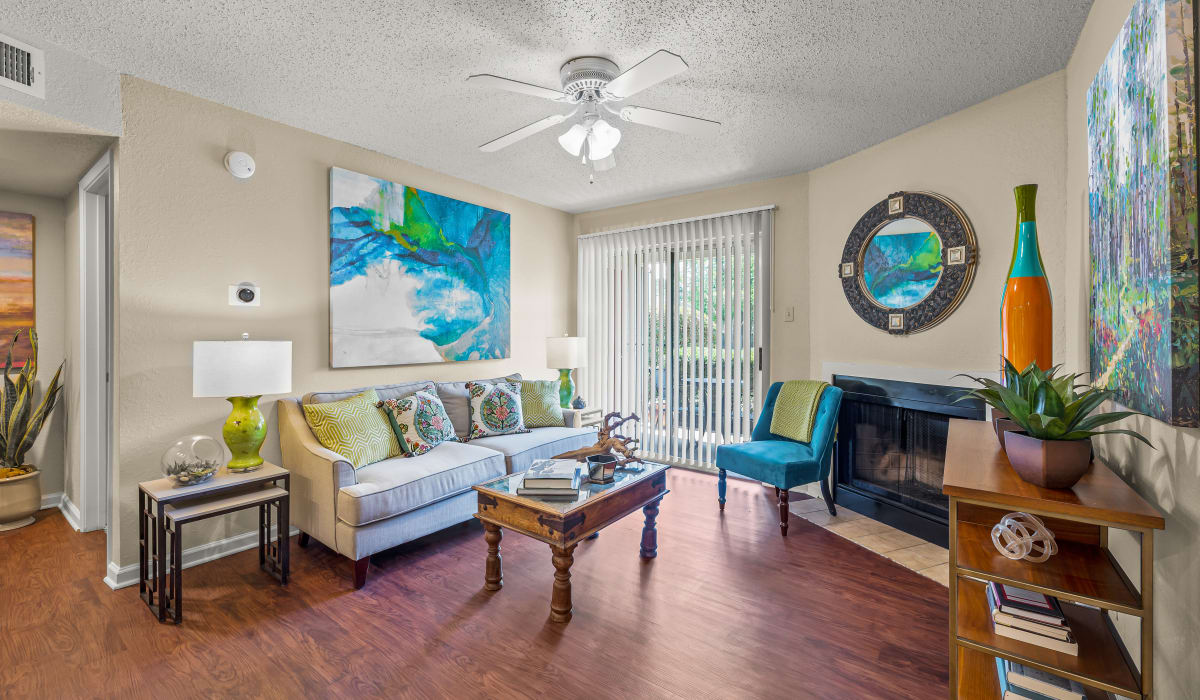Living room with attached balcony at Millicent Crossing in Shreveport, Louisiana
