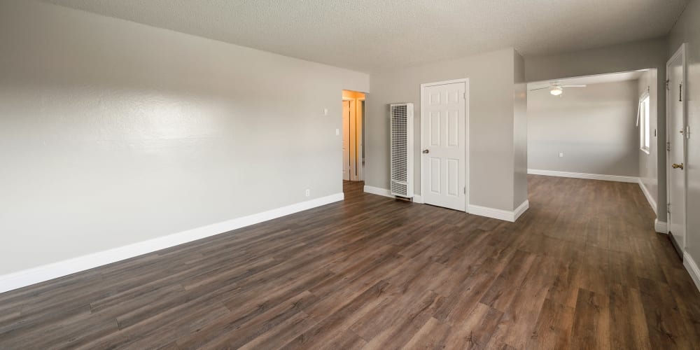 Living room area with plenty of space at Garden Court Apartments in Alameda, California