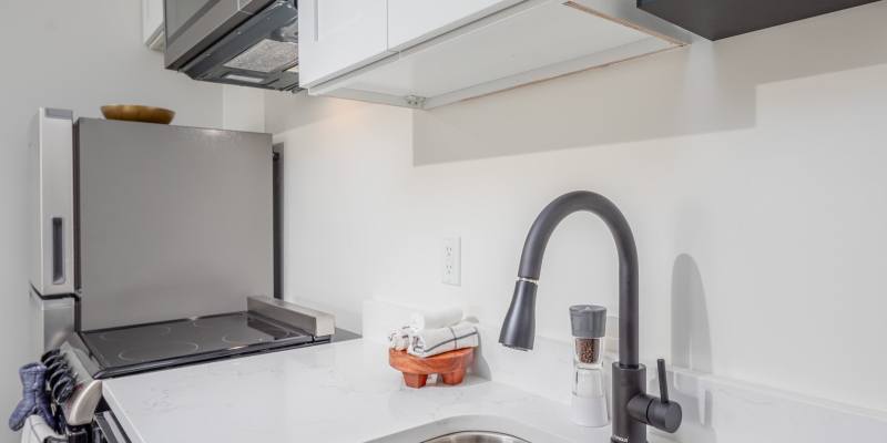 Studio apartment kitchen with dishwasher and stainless-steel appliances at Hermitage Studios in Hermitage, Tennessee