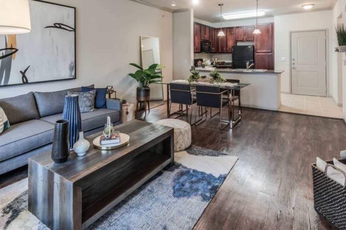 Modern living room with open kitchen at Villas At Bunker Hill, Houston, Texas