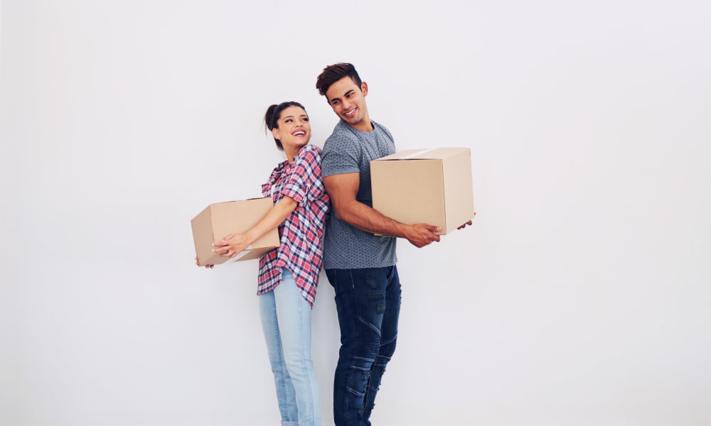 Individuals holding boxes from a recent auction at Devon Self Storage