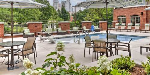 Outdoor pool and patio with lounge chairs near Cedar Flats in Charlotte, North Carolina