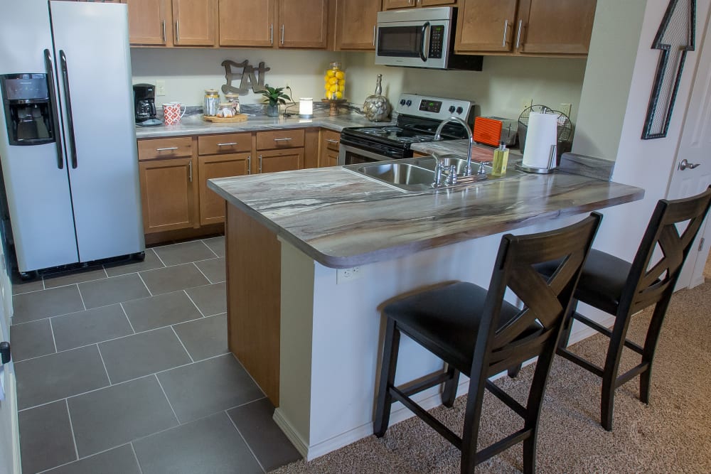 Kitchen with bar style seating at lPortofino Apartmentsin Wichita, Kansas