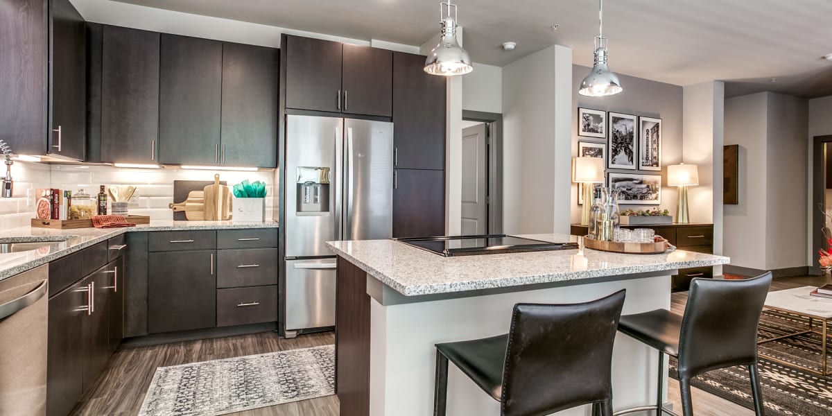 Kitchen with stainless steel appliances and granite counters at Oro Stone Oak in San Antonio, Texas