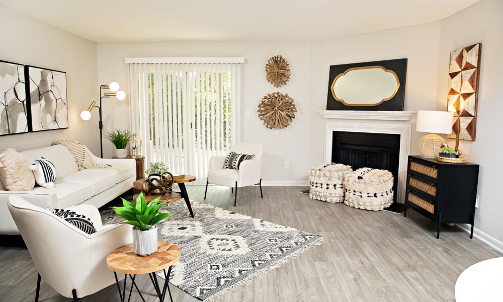 Wood flooring and a fireplace in an apartment kitchen at Dwell at Carmel in Charlotte, North Carolina