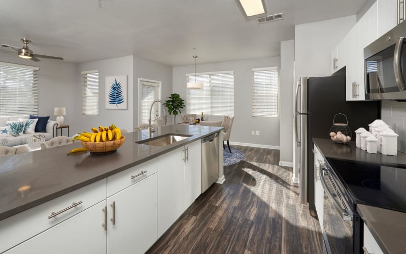 Renovated kitchen with white cabinets at The Rail at Inverness in Englewood, Colorado