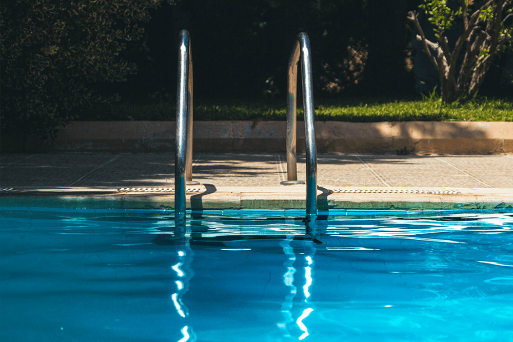 Woman at the edge of the pool relaxing at The Residences at Sawmill Station in Morton Grove, Illinois