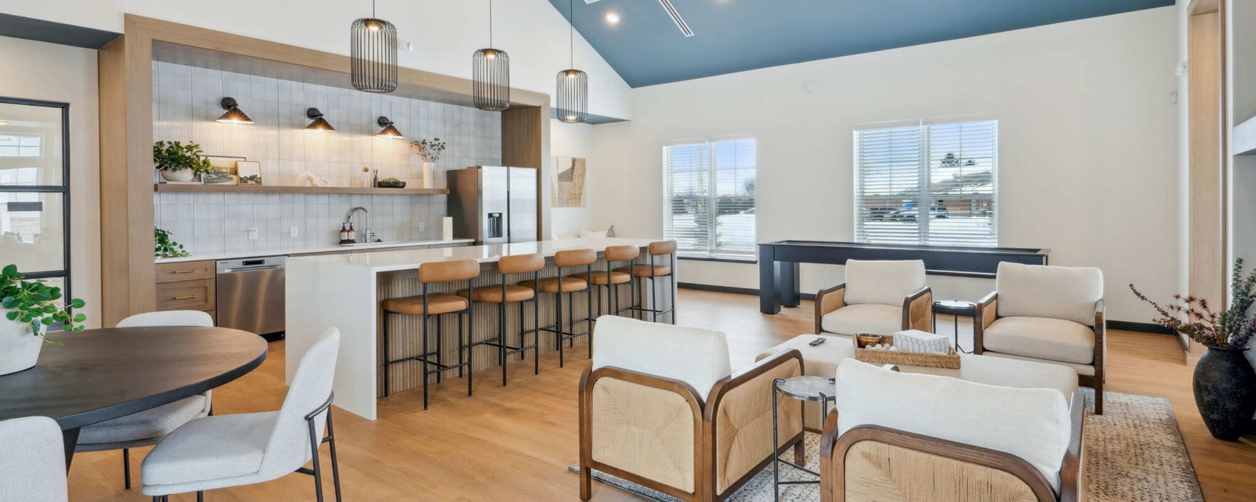 Modern fitness center with exercise equipment, high ceilings, and large windows for natural light at The Mills in Sidney, Ohio