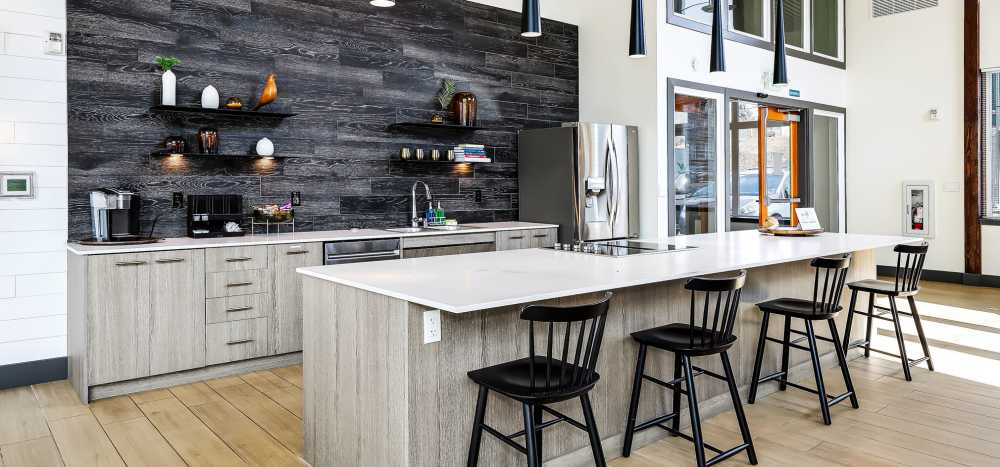 Community kitchen with barcounter area at Allegro in Lynnwood, Washington 
