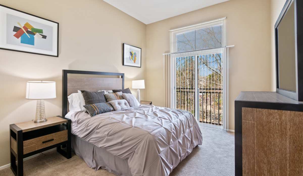 Bedroom with balcony at Ontario Town Square Townhomes in Ontario, California