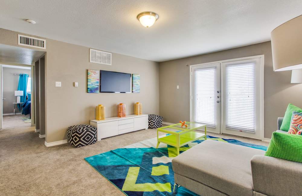 Living room with chair, tv and patio at Ascent at Lake Worth in Fort Worth, Texas