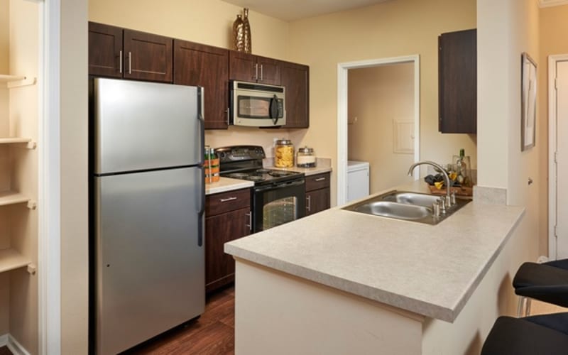 Renovated kitchen with stainless-steel appliances at Legend Oaks Apartments in Aurora, Colorado