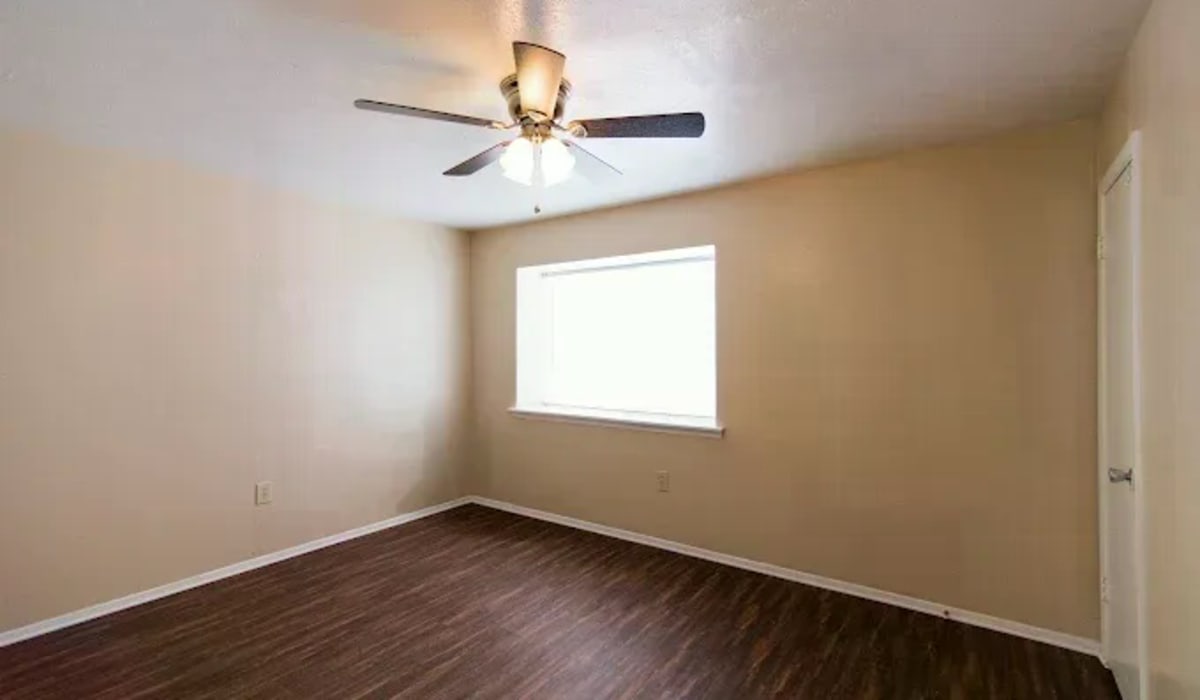 Apartment bedroom with ceiling fan at Tradewind Apartments in Mesquite,Texas