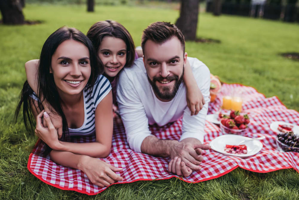 Residents enjoying a picnic outside at Cornfield Apartments in Ellington, Connecticut