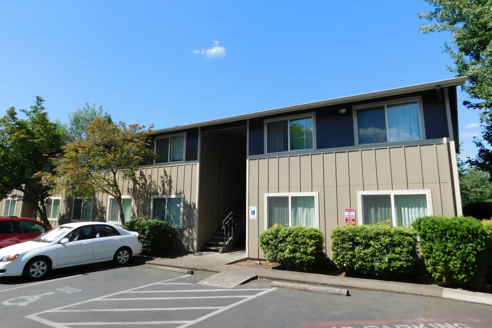 Apartment exterior with parking lot at Fountain Court in Springfield, Oregon