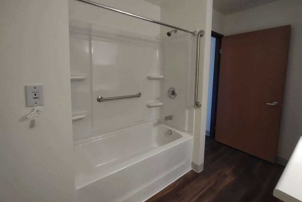 Bathroom with a bathtub at Willow Creek Apartments in Escanaba, Michigan