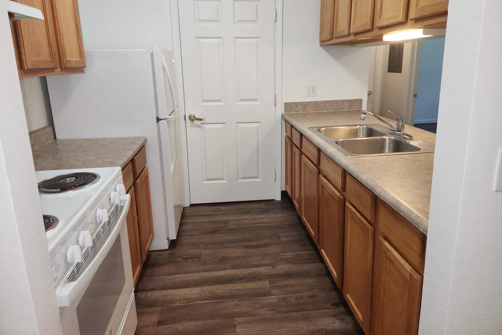 Modern kitchen with wooden cabinets at Bramblewood in New Haven, Michigan