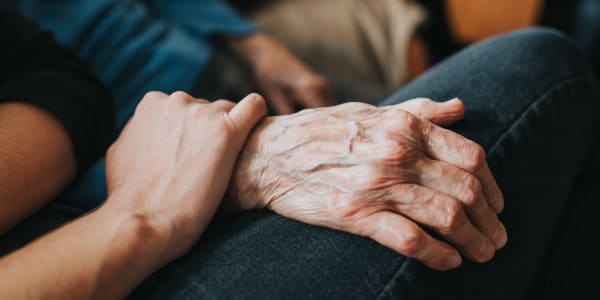 Caretaker comforting a resident at Bell Tower Residence Assisted Living in Merrill, Wisconsin