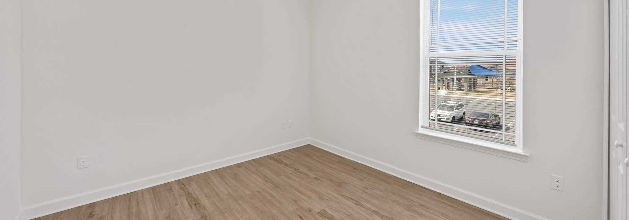 Bedroom with wood-style flooring at Fletcher Black in Panama City, Florida
