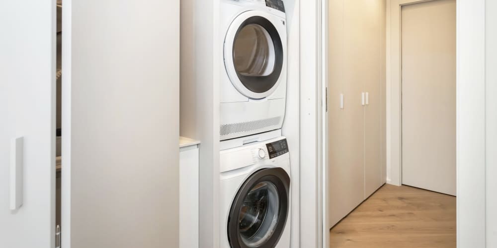 Washer and dryer in modern laundry closet at Icon Park in Sterling Heights, Michigan