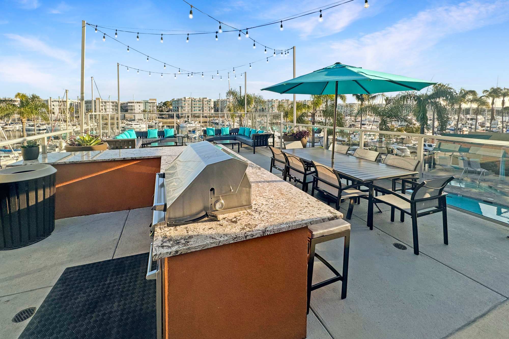 Rooftop lounge with firepit and an overlooking view at Harborside Marina Bay Apartments in Marina del Rey, California