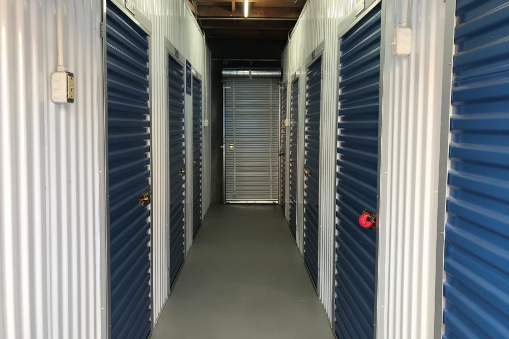 Indoor hallway access to storage units at Storage Solutions in Pomona, California