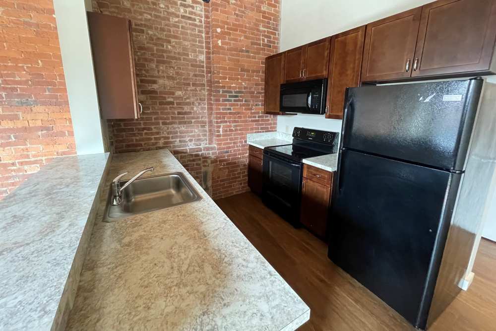 Kitchen with appliances at Capitol Lofts in Hartford, Connecticut