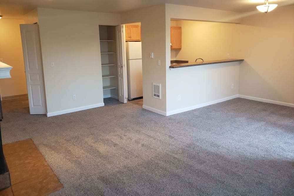 Living room with soft carpet in a model home at The Knoll Redmond in Redmond, Washington