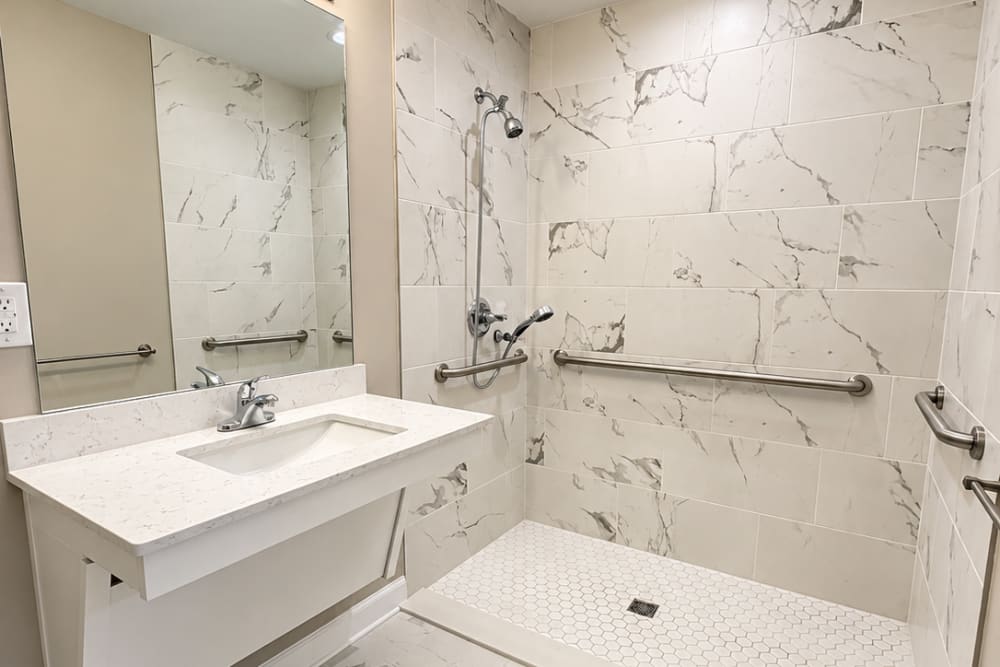 Bathroom with roll-in shower at Village Springs Apartments in Defuniak Springs, Florida