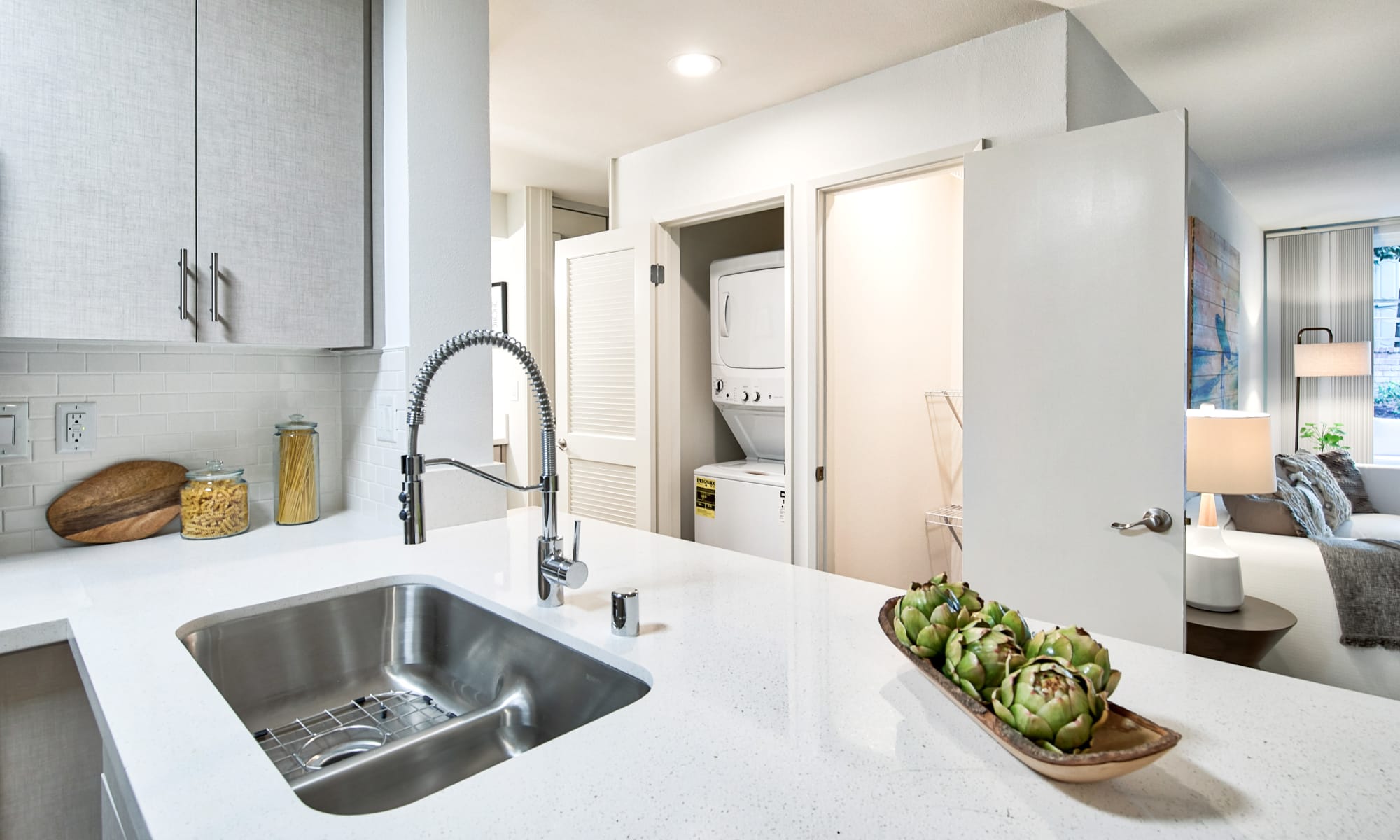 Kitchen with stainless-steel appliances and plenty of cabinetry at The Meadows in Culver City, California