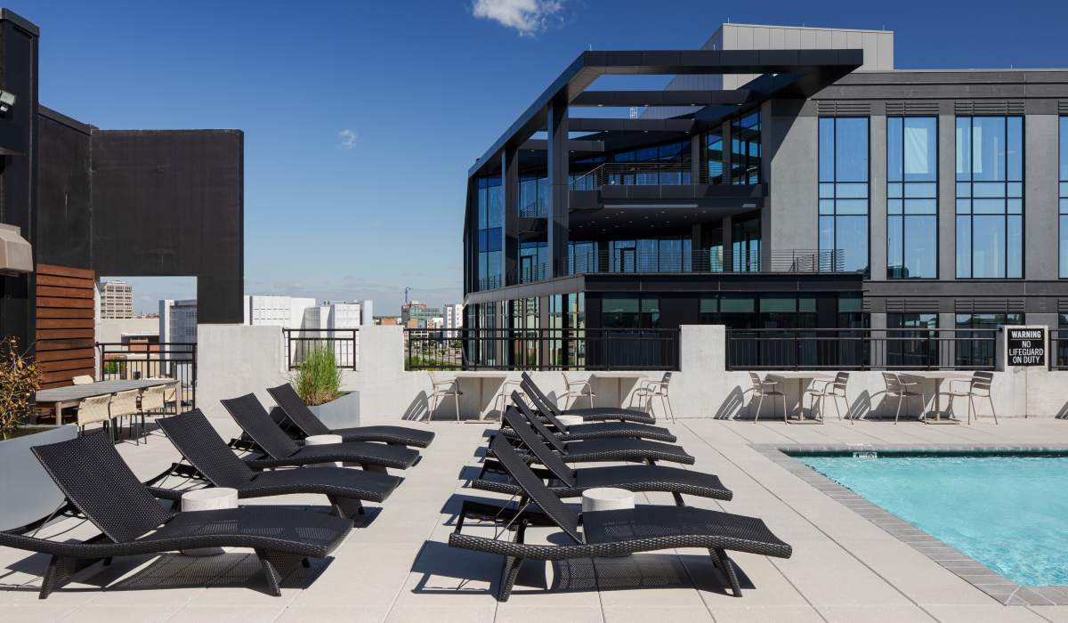 Sun-drenched lounge area by the swimming pool at Venable Durham Apartments in Durham, North Carolina
