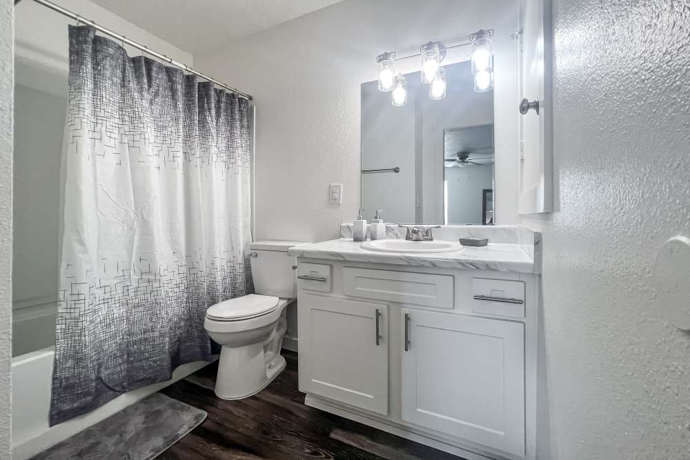 Bright bathroom with vanity mirror at Savannah Square & Savannah Harbor in Norman, Oklahoma