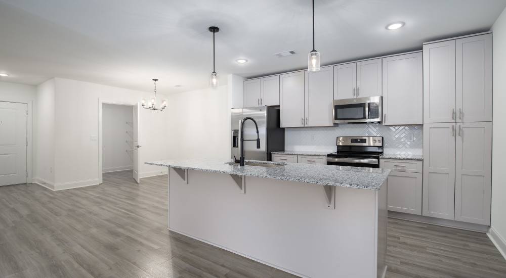 Living room with connecting kitchen at Retreat at Redstone in Crestview, Florida