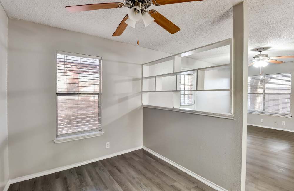 Model apartment with ceiling fan and wood-style flooring at The Lodge at Timberhill, San Antonio, Texas