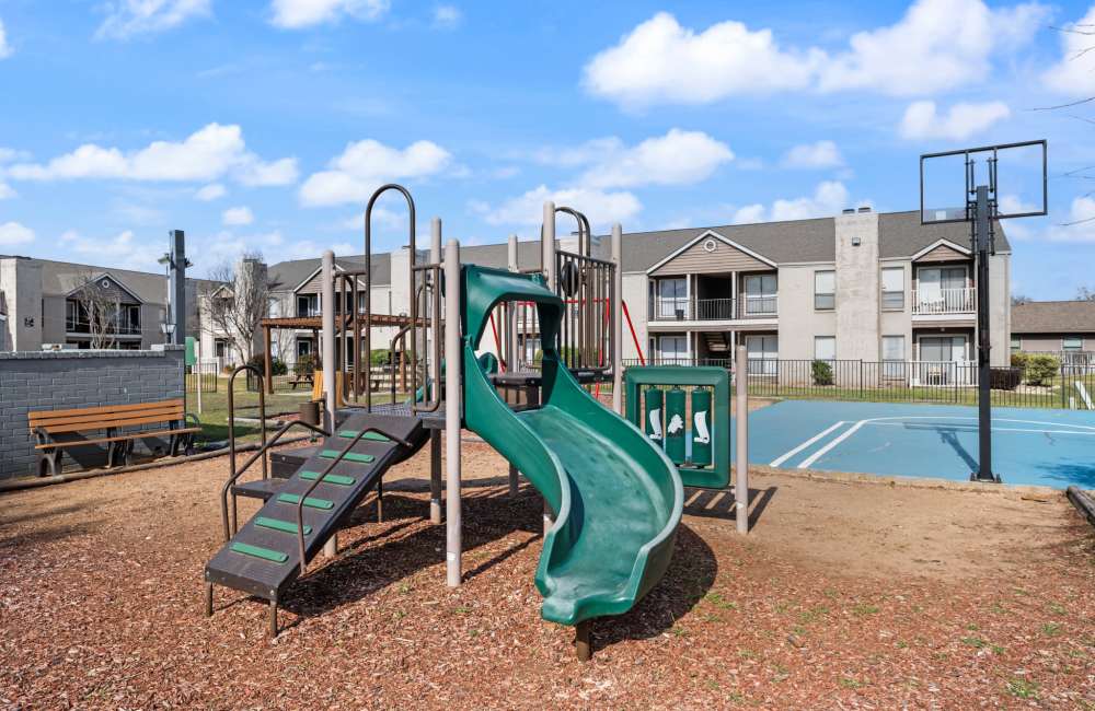 Play area with slides at Derby Park Apartments in Round Rock, Texas