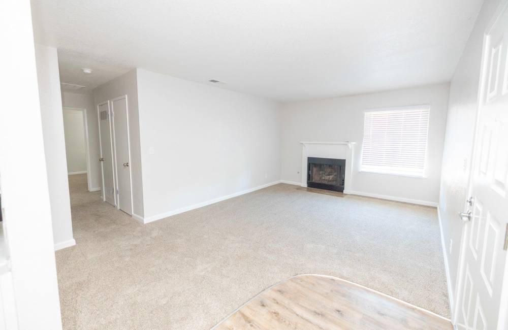 Living room with fireplace at Riverview Gardens Apartments in Fresno, California