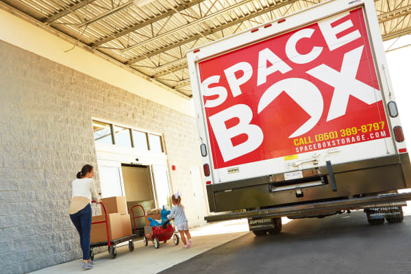 A family moving using the free moving truck at Spacebox Storage Apopka in Apopka, Florida.